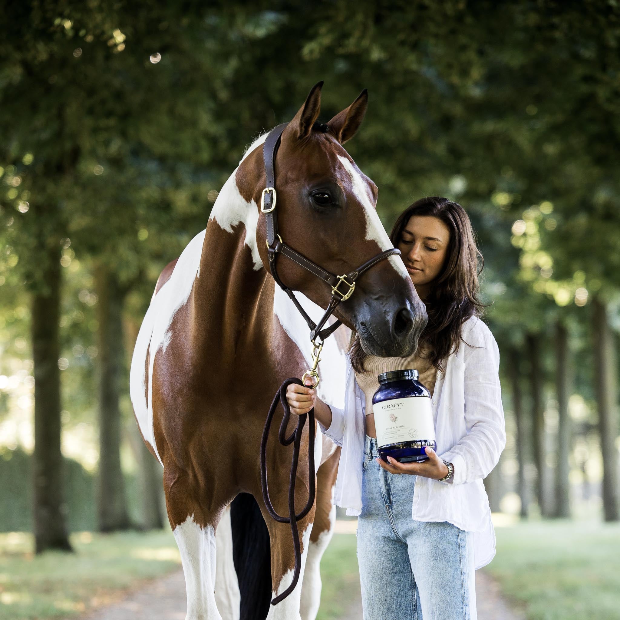 Horse with owner holding Curafyt supplement