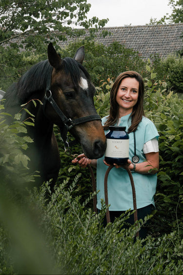 Veterinarian Valerie Founder Curafyt holding a horse and a supplements jar