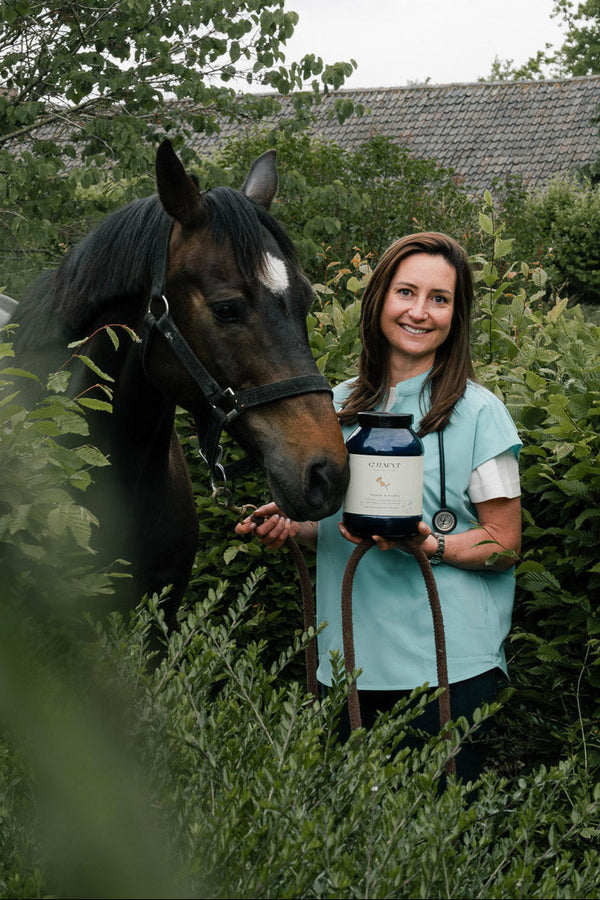 Veterinarian Valerie Founder Curafyt holding a horse and a supplements jar