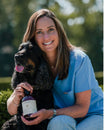 Valérie De Clerck, DVM, with a dog and a Curafyt supplement